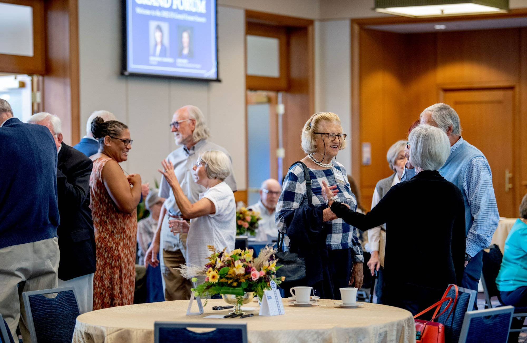 Grand Forum members smile during a lecture